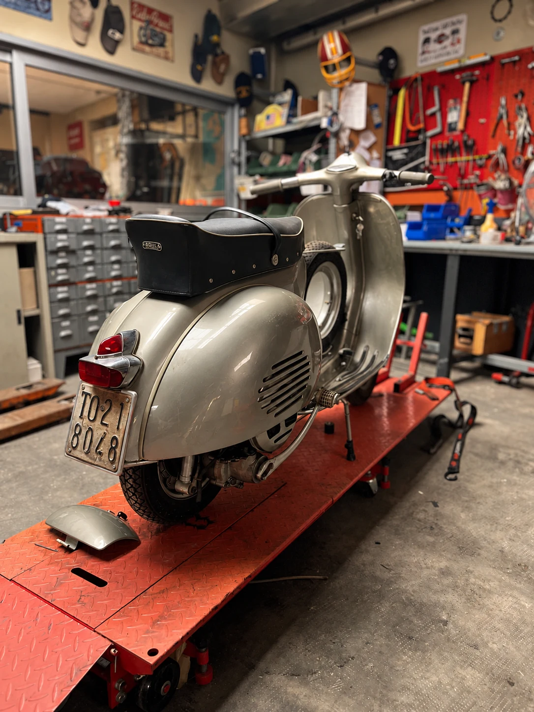 The Vespa GS 150 in the workshop during its conservative restoration, with its original Turin number plate.