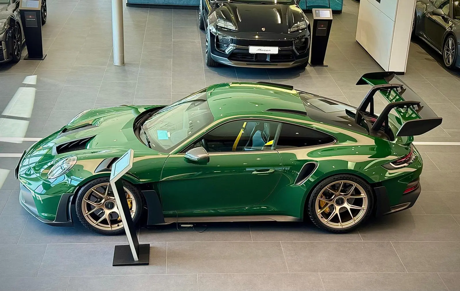 Madame Claude displayed in the Porsche showroom, seen from above