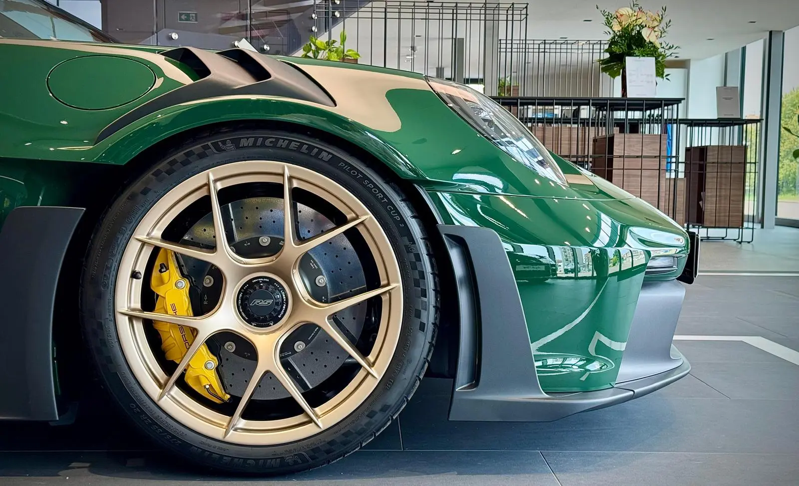 Front centre-lock wheel and yellow brake caliper of Madame Claude