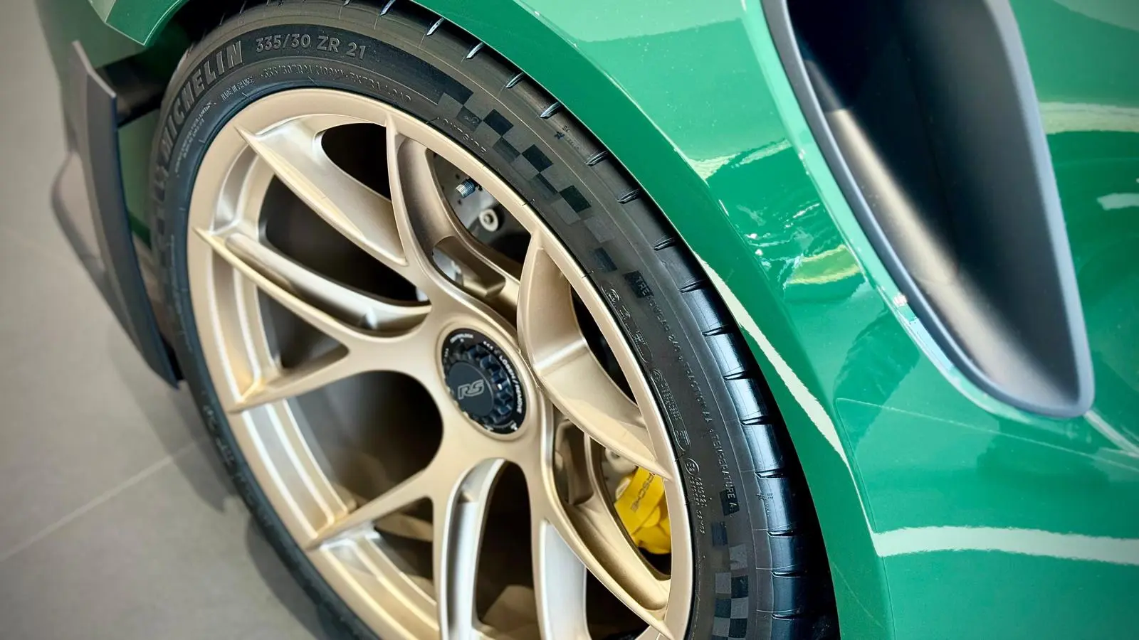 Rear wheel, yellow brake caliper and carbon intake of Madame Claude