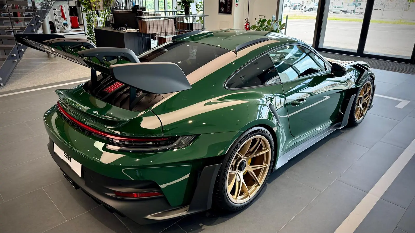 Rear three-quarter view of Madame Claude in the Porsche showroom