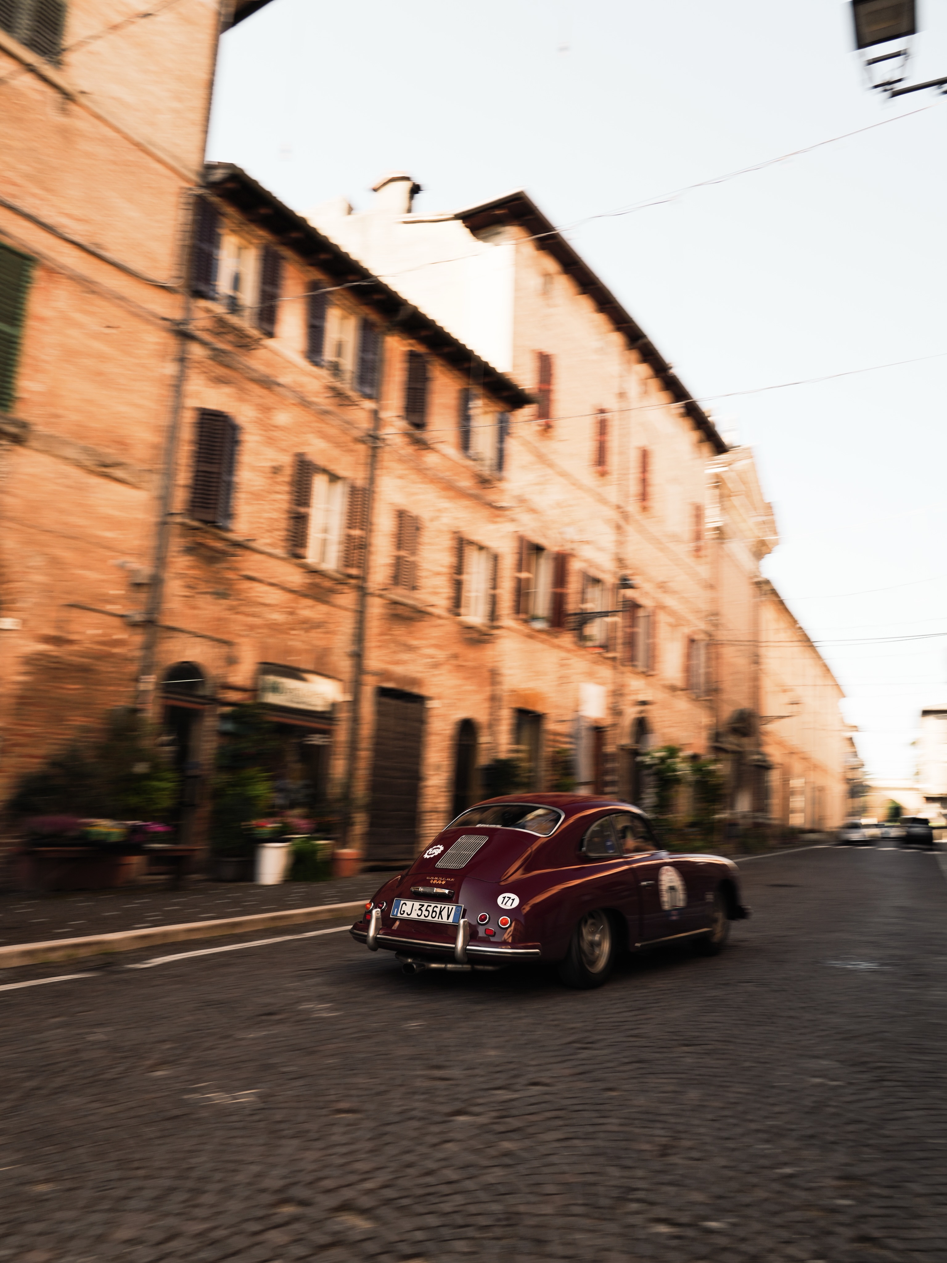 Princess Grace driving through an Italian historic centre