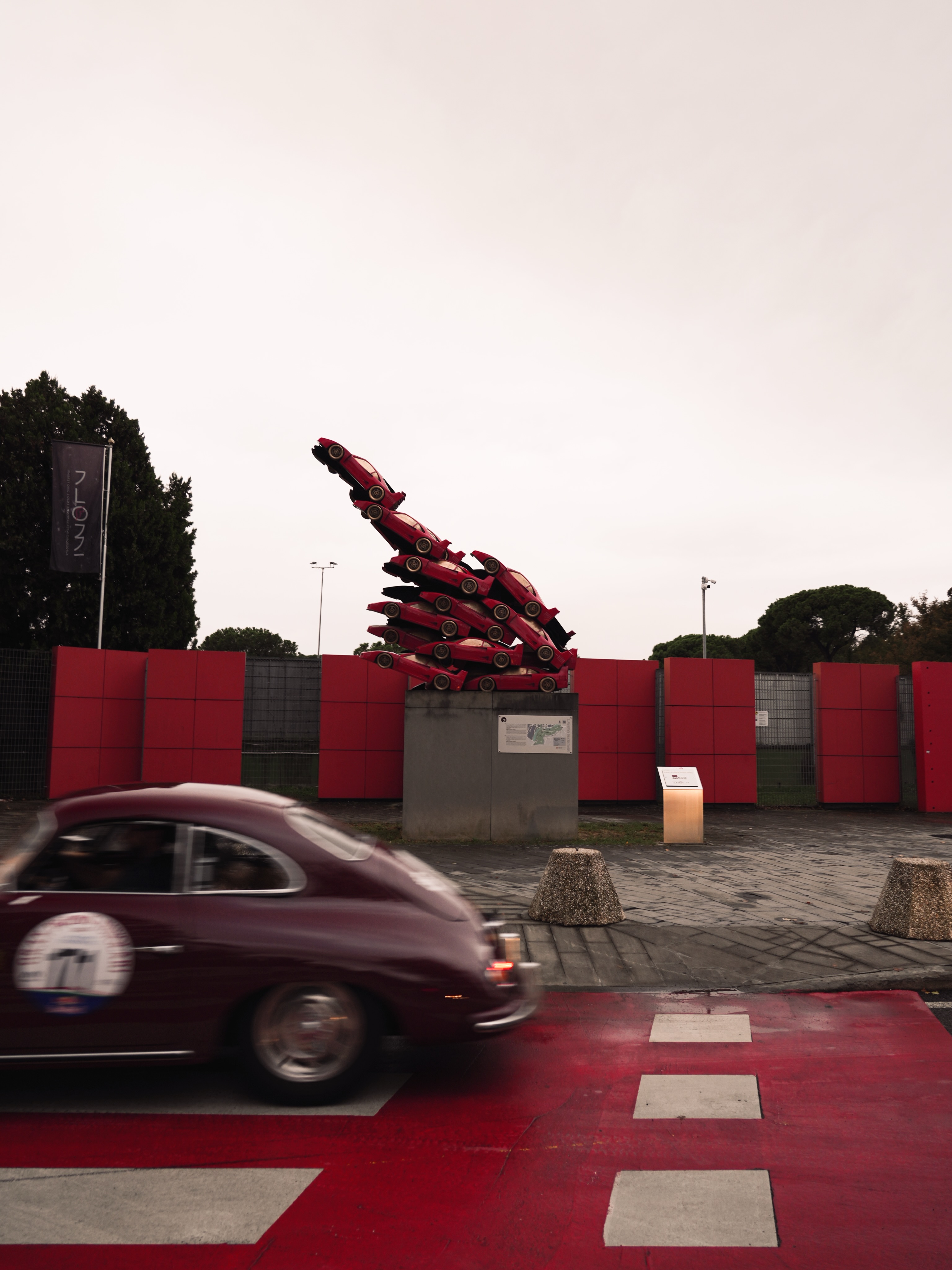 Princess Grace passing the Ferrari sculpture in motion