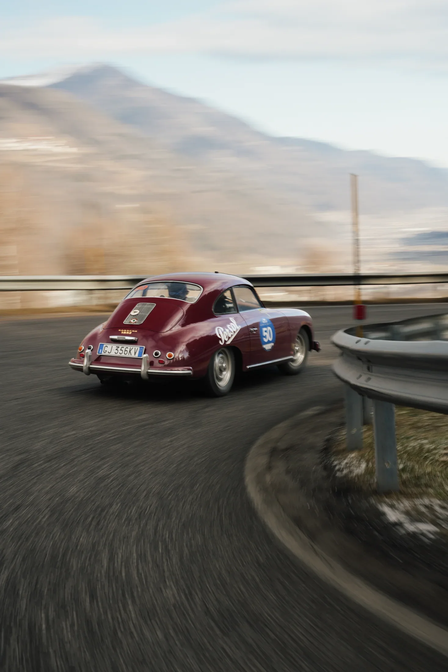 The Porsche 356 driving through the alpine road during Winter Marathon.