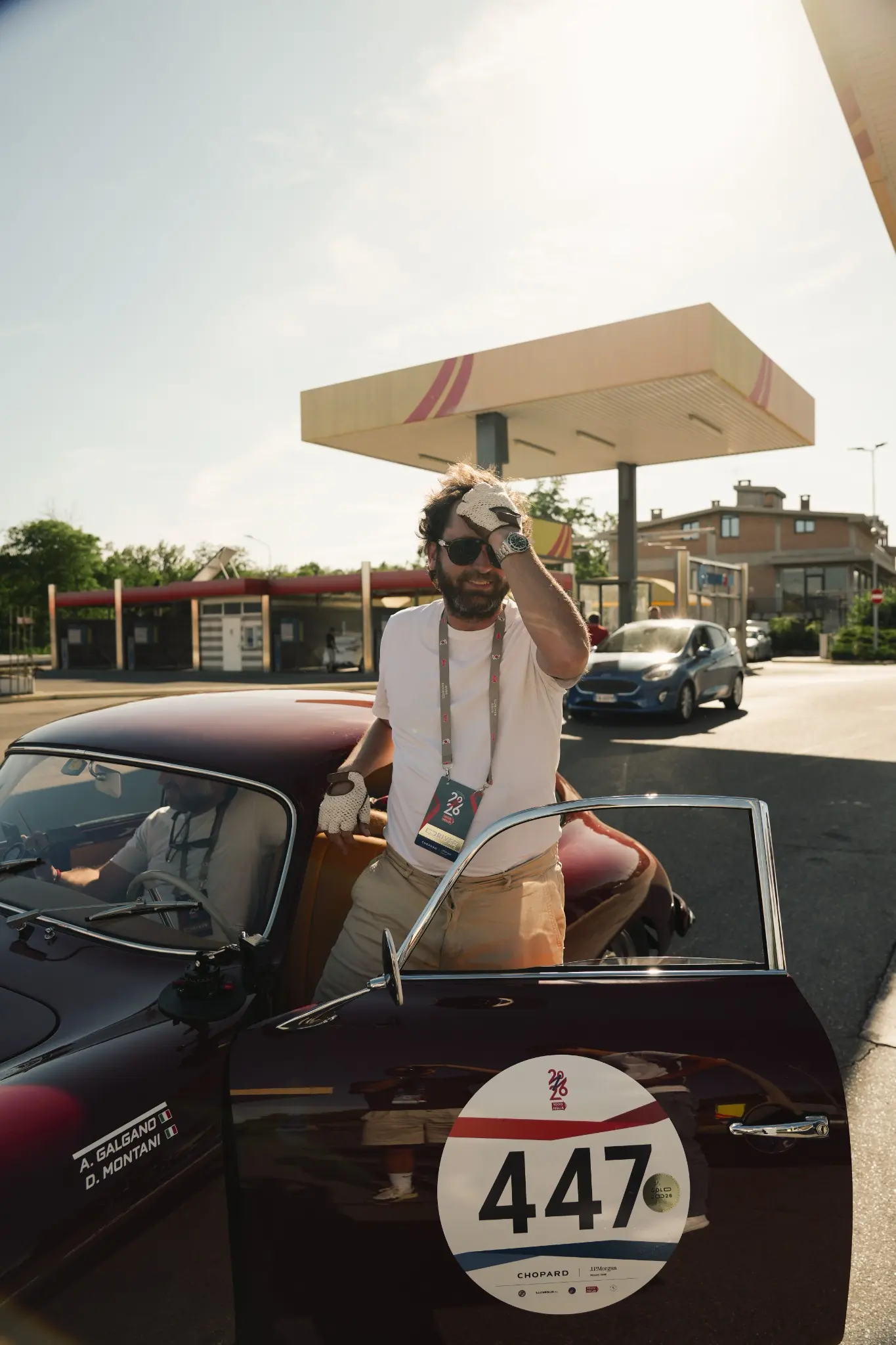 Driver beside a TURE Porsche during Mille Miglia 2026