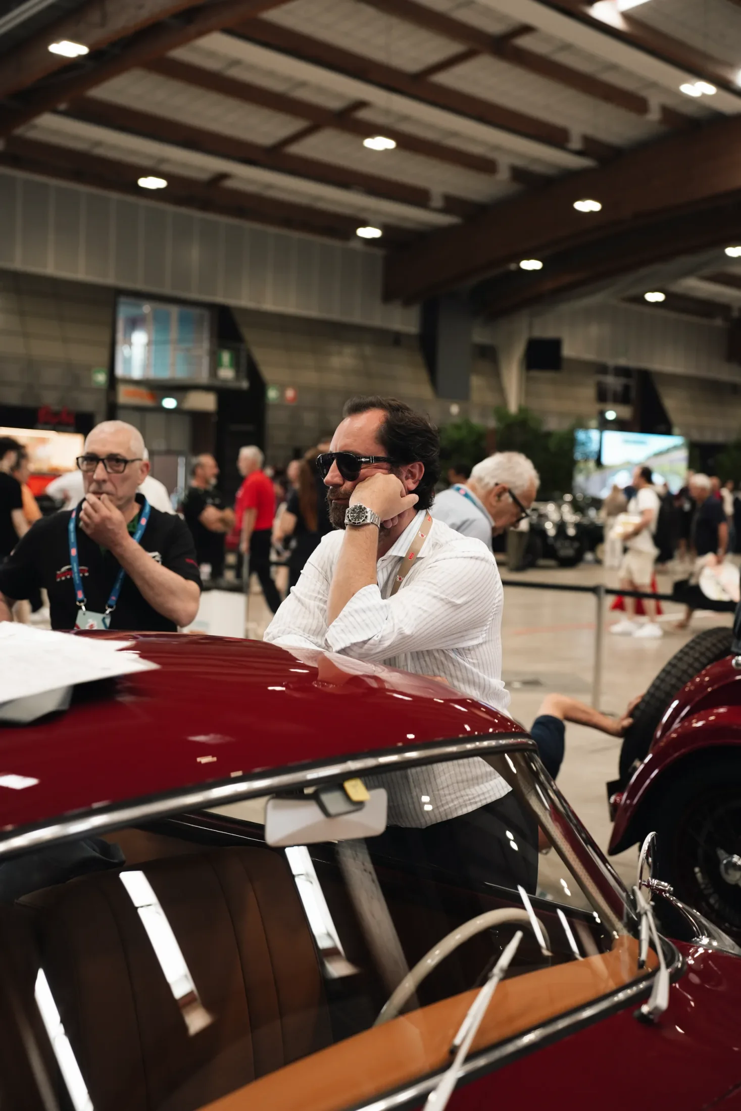 TURE founder beside a burgundy Porsche during 1000 Miglia registration